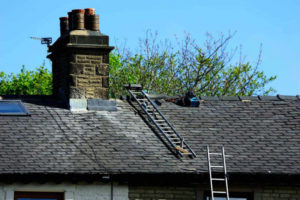 Ladder leaning against house for a chimney inspection