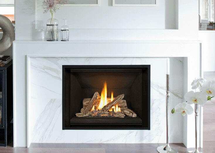 Valor H5 Gas Fireplace lit in living room with white marble surround and white mantle