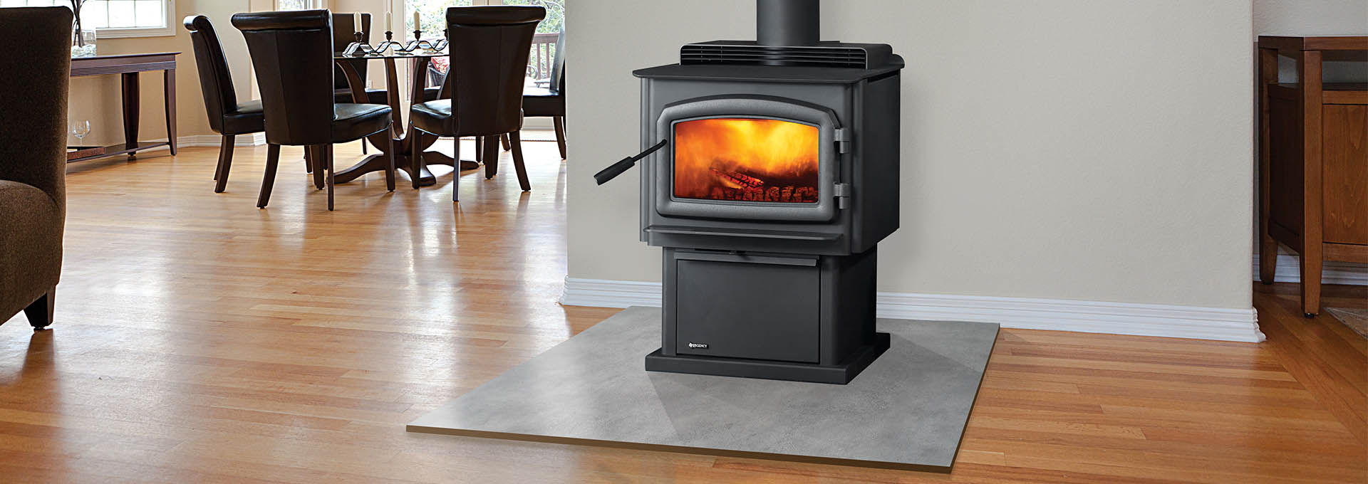 Regency F2450 Wood Stove lit in living room with dining room view behind it