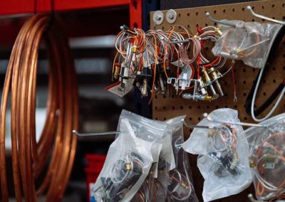 Close up of wiring supplies hanging on cork board in warehouse