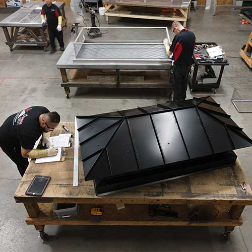 Aerial view of warehouse where technicians are fabricating chimney caps, chase covers, and dampers