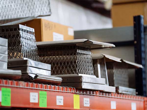 New inventory of chimney caps on shelf in warehouse