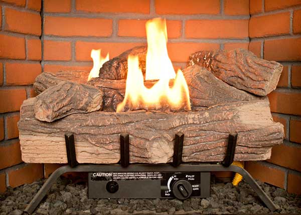 Owens Chimney Original Photo of Lit Gas Fireplace Logs Close up of gas fireplace logs with fire burning in a brick fireplace