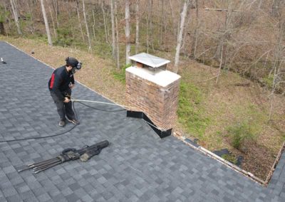 Technician prepping for repair and restoration of chimney flashing