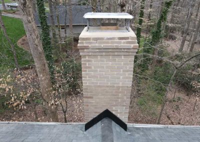 Close up of completed new chimney cap installation on restored chimney
