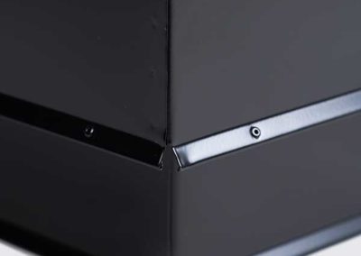 Close up of corner of black chimney chase cover