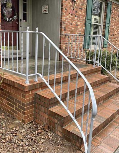 Brick residential front steps with missing mortar repaired and pressure washed after repairs