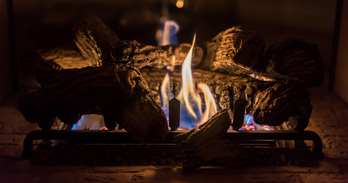 Stock photo of gas logs close up of gas logs with a blue and yellow flame