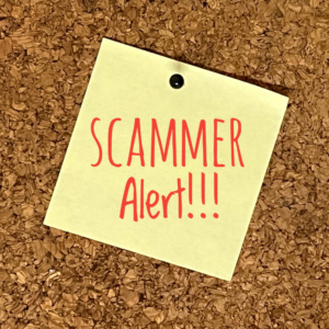 A yellow sticky note that says "SCAMMER Alert!!!"