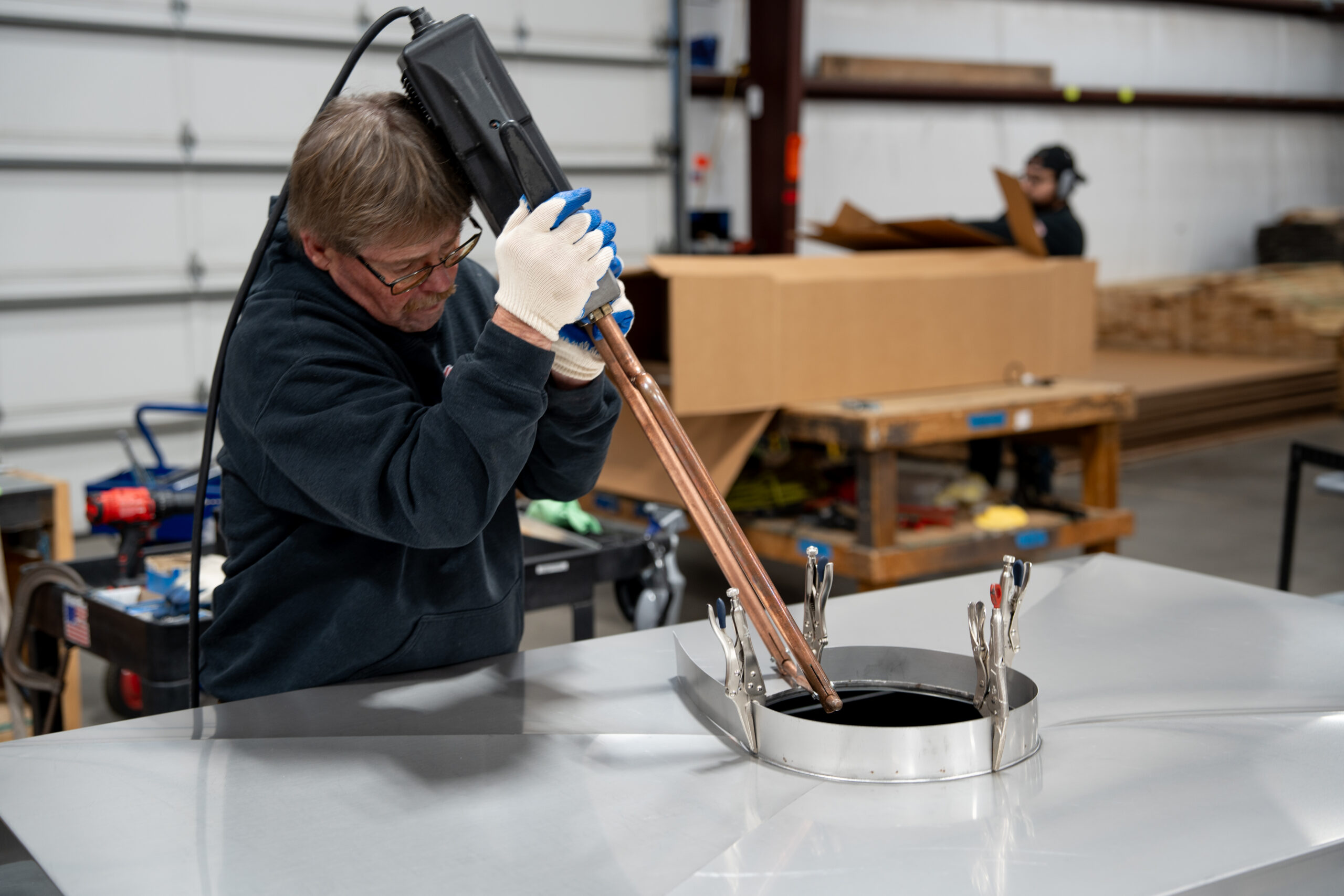 Custom chimney cap being fabricated in warehouse